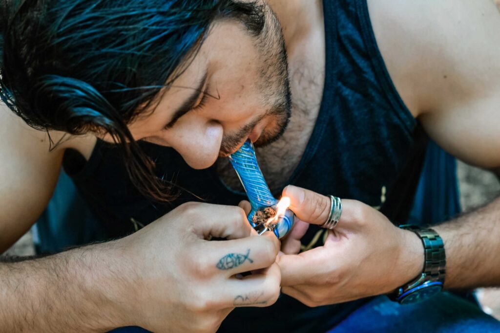 A man smoking JAXON CBD flower from a pipe
